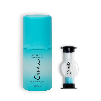 A bottle of Canale Nourish Vitamin Enriching Foam next to a small sand timer branded with the Canale logo against a white background.